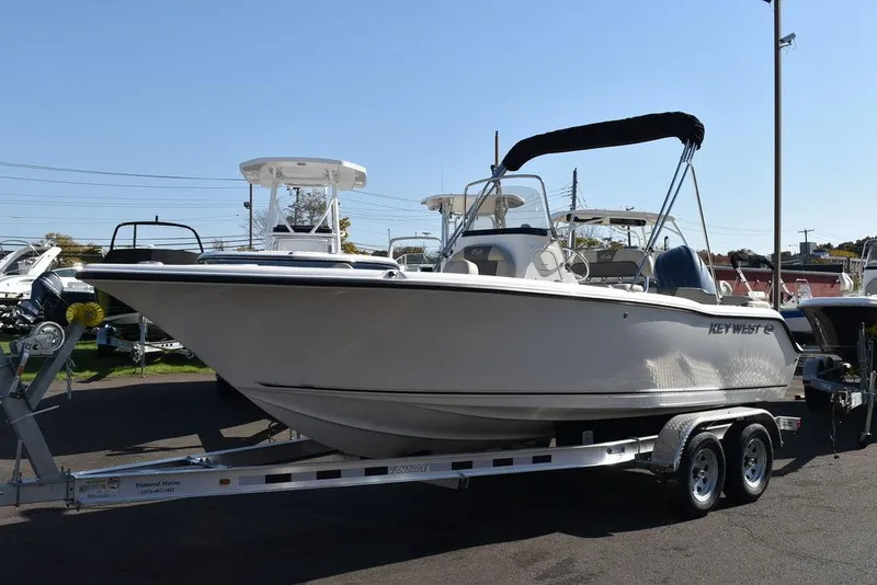 Slide: The Image of 2025 Key West 203 FS boat on trailer, displayed outdoors. - 4