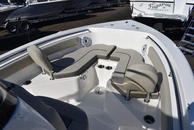 Slide: The Image of 2025 Key West 203 FS boat interior with cushioned seating and cup holders. - 7