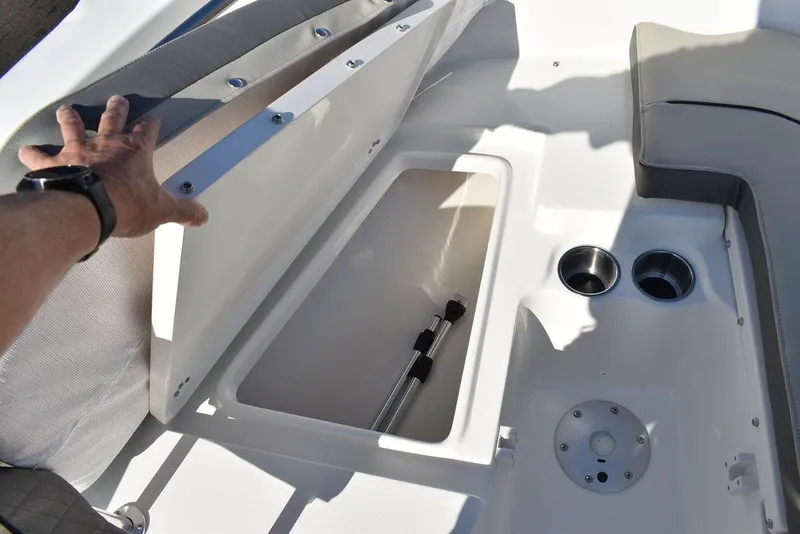 Slide: The Image of 2025 Key West 203 FS boat storage compartment with cup holders and seating. - 9