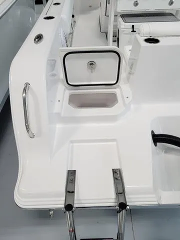 Slide: The Image of 2025 Sportsman Heritage 231 boat interior with storage compartment and ladder. - 12