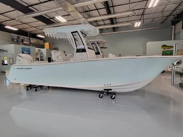 Slide: The Image of 2025 Sportsman Heritage 231 boat displayed in a showroom. - 15