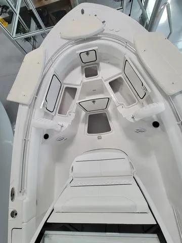 Slide: The Image of 2025 Sportsman Heritage 231 boat interior with storage compartments and seating. - 16