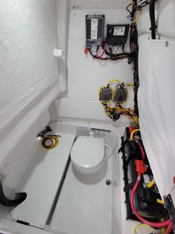 Slide: The Image of 2025 Sportsman Heritage 231 boat interior with wiring and marine toilet. - 24