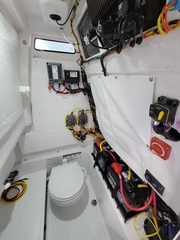 Slide: The Image of Interior of 2025 Sportsman Heritage 231 boat, showcasing electrical systems and wiring. - 25