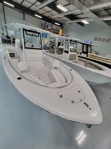 Slide: The Image of 2025 Sportsman Heritage 231 boat displayed in showroom, sleek design, modern features. - 3