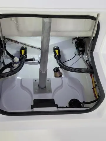 Slide: The Image of 2025 Sportsman Heritage 231 boat interior compartment with mechanical components. - 30