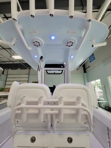 Slide: The Image of 2025 Sportsman Heritage 231 boat interior with rod holders and LED lights. - 33