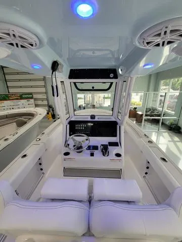 Slide: The Image of 2025 Sportsman Heritage 231 boat interior with modern dashboard and seating. - 34