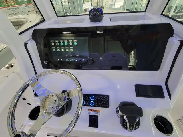 Slide: The Image of 2025 Sportsman Heritage 231 boat dashboard with modern controls and touchscreen display. - 35