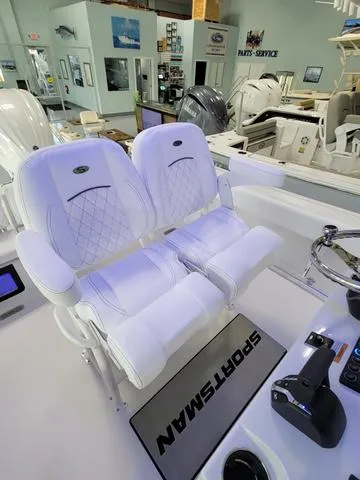 Slide: The Image of 2025 Sportsman Heritage 231 boat interior with plush white seating and modern controls. - 37