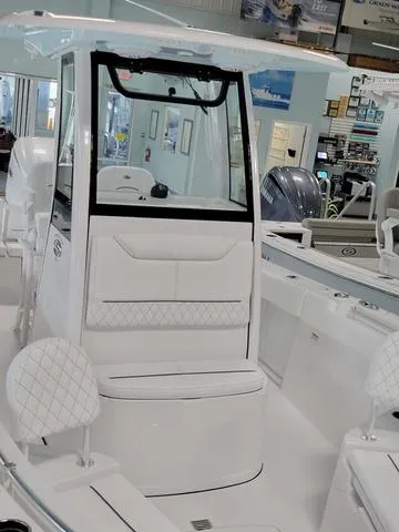 Slide: The Image of 2025 Sportsman Heritage 231 boat interior with modern seating and controls. - 4