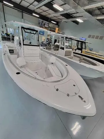 Slide: The Image of 2025 Sportsman Heritage 231 boat displayed in a showroom. - 42