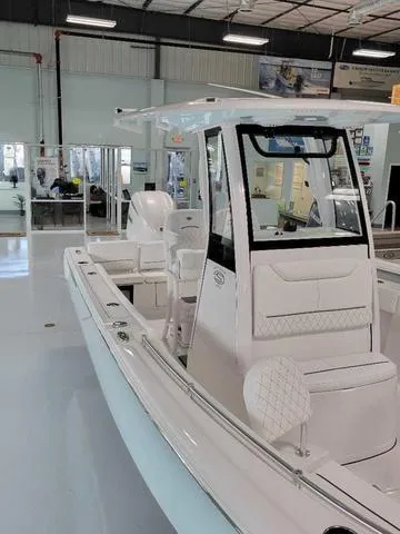 Slide: The Image of 2025 Sportsman Heritage 231 boat in showroom, featuring sleek design and modern amenities. - 44