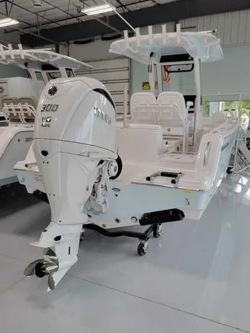 Slide: The Image of 2025 Sportsman Heritage 231 boat with powerful 300 HP engine in showroom. - 47