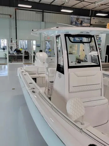 Slide: The Image of 2025 Sportsman Heritage 231 boat in showroom, featuring sleek design and modern amenities. - 5