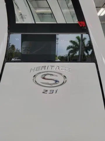 Slide: The Image of 2025 Sportsman Heritage 231 boat with logo and emblem in showroom. - 7