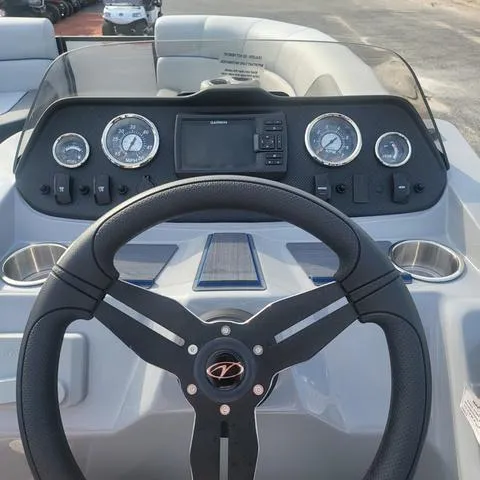 Slide: The Image of 2025 Veranda Vista Sport 20 RC boat dashboard with steering wheel and gauges. - 14