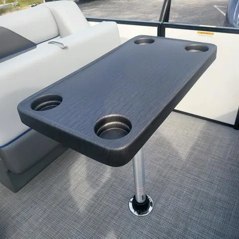 Slide: The Image of Veranda Vista Sport 20 RC 2025 boat interior with table and cup holders. - 22