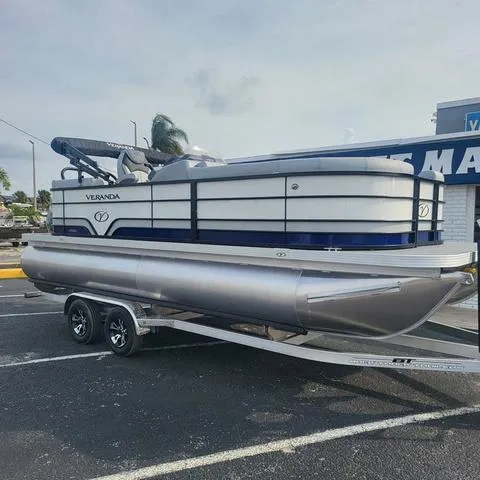 Slide: The Image of 2025 Veranda Vista Sport 20 RC pontoon boat on trailer in parking lot. - 24