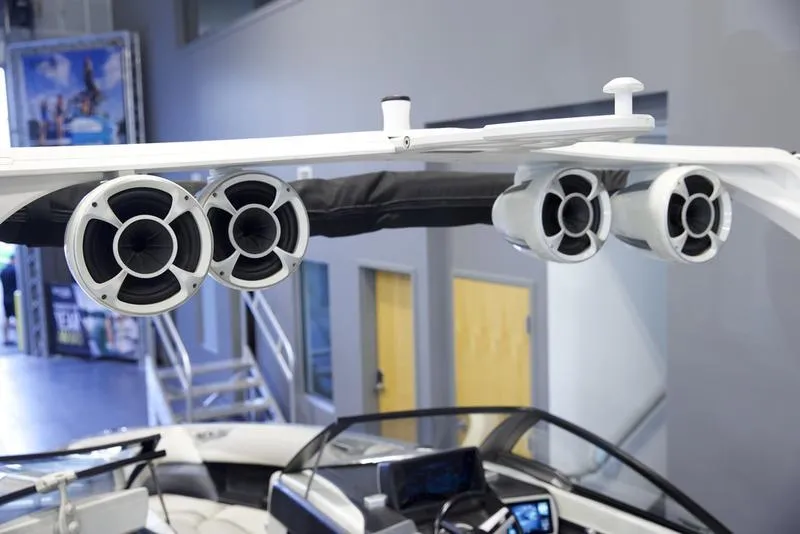 Slide: The Image of 2016 Malibu 23 LSV boat with mounted speakers and sleek interior design. - 15