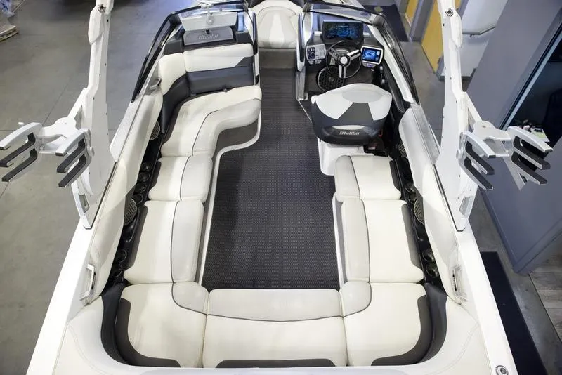 Slide: The Image of 2016 Malibu 23 LSV boat interior with spacious seating and modern dashboard. - 18