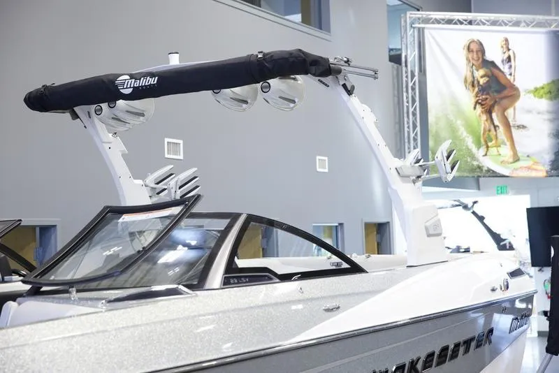 Slide: The Image of 2016 Malibu 23 LSV boat displayed indoors with wakeboard tower. - 19