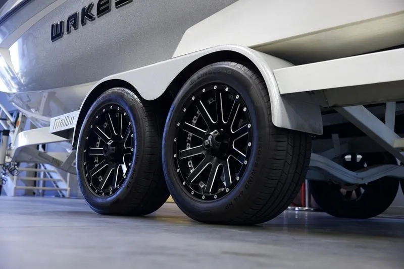 Slide: The Image of 2016 Malibu 23 LSV boat trailer with stylish black wheels. - 3