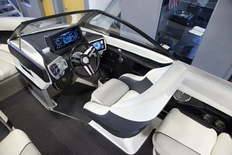 Slide: The Image of Interior of 2016 Malibu 23 LSV boat with modern dashboard and seating. - 7