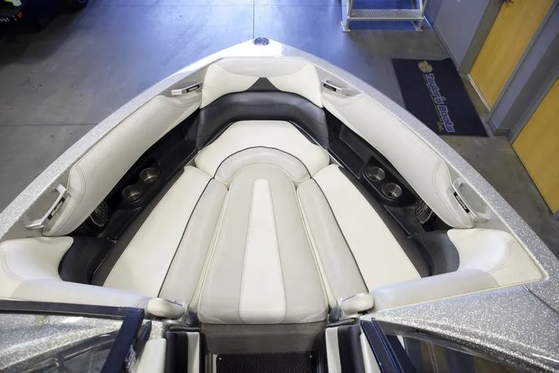 Slide: The Image of 2016 Malibu 23 LSV boat interior with white and gray seating. - 9