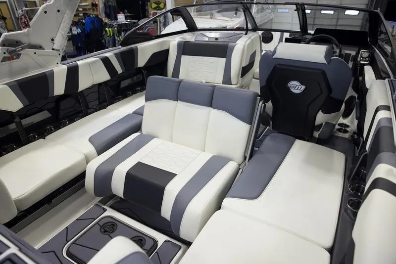 Slide: The Image of 2025 Malibu 22 MXZ boat interior with luxurious seating and modern design. - 11