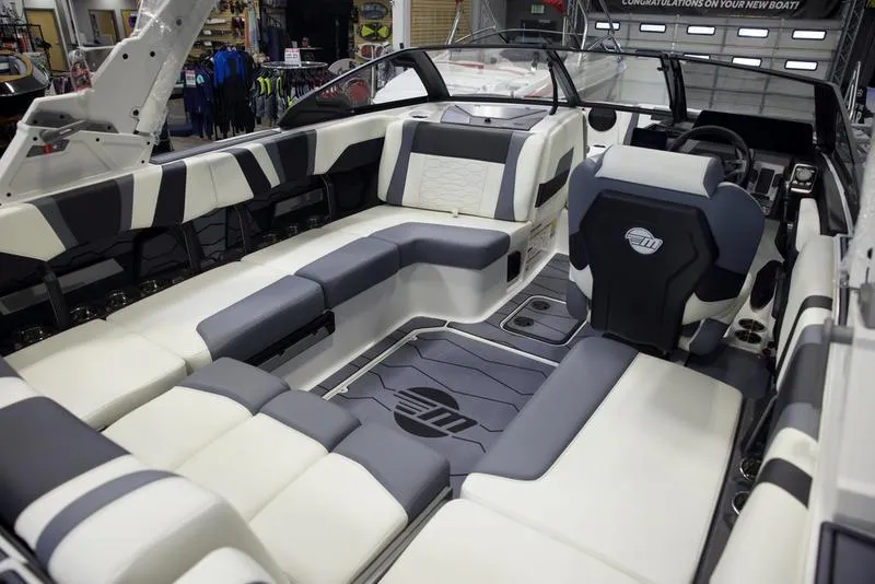 Slide: The Image of 2025 Malibu 22 MXZ boat interior with luxurious seating and modern design. - 12