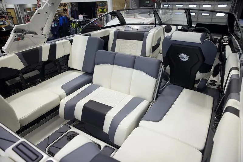 Slide: The Image of 2025 Malibu 22 MXZ boat interior with modern seating and sleek design. - 14