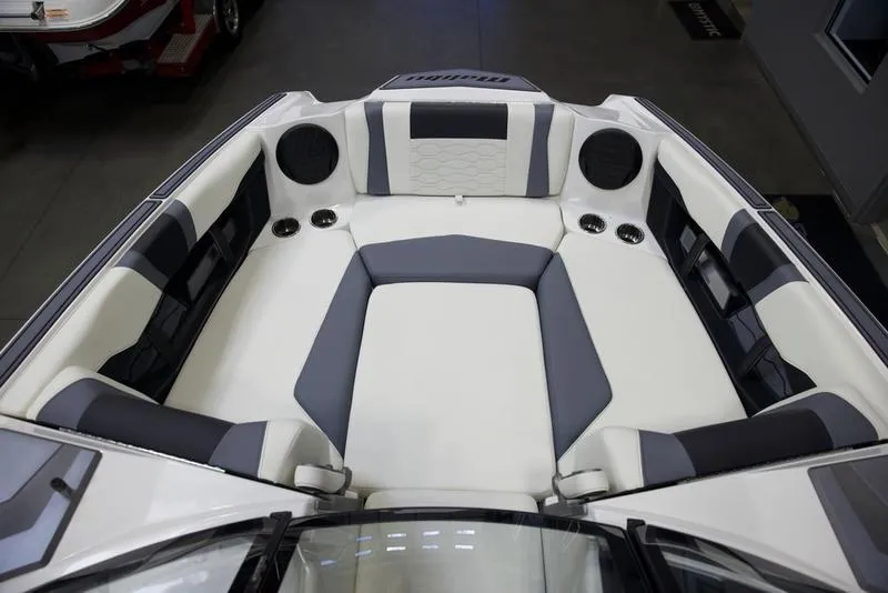Slide: The Image of 2025 Malibu 22 MXZ boat interior with gray and white seating. - 16