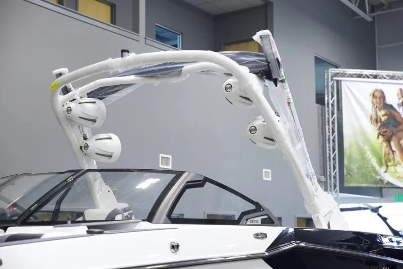 Slide: The Image of 2025 Malibu 22 MXZ boat with sleek design and advanced audio system. - 19