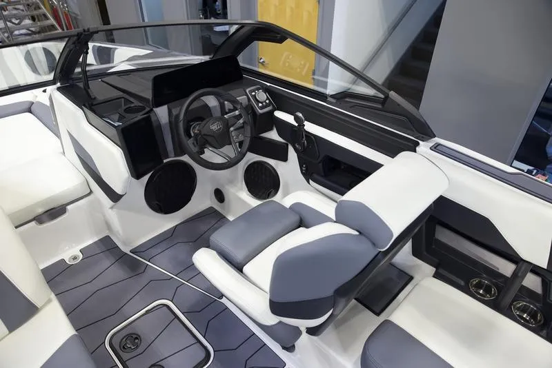 Slide: The Image of 2025 Malibu 22 MXZ boat interior with modern dashboard and seating. - 20