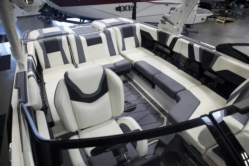 Slide: The Image of 2025 Malibu 22 MXZ boat interior with modern seating design. - 21