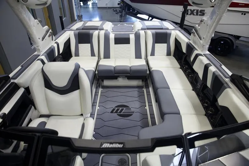 Slide: The Image of 2025 Malibu 22 MXZ boat interior with luxurious seating and modern design. - 23