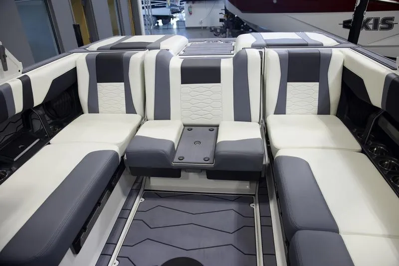 Slide: The Image of 2025 Malibu 22 MXZ boat interior with modern seating design. - 24