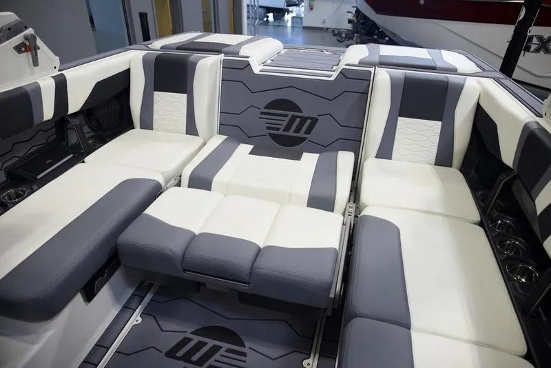 Slide: The Image of 2025 Malibu 22 MXZ boat interior with modern seating and stylish design. - 25