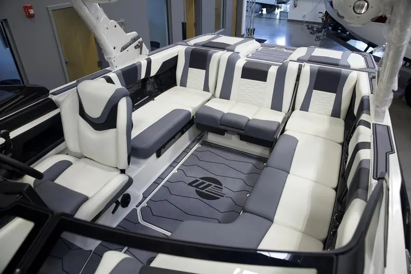 Slide: The Image of Luxurious interior of 2025 Malibu 22 MXZ boat with modern seating design. - 26