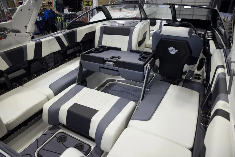Slide: The Image of 2025 Malibu 22 MXZ boat interior with modern seating and sleek design. - 8