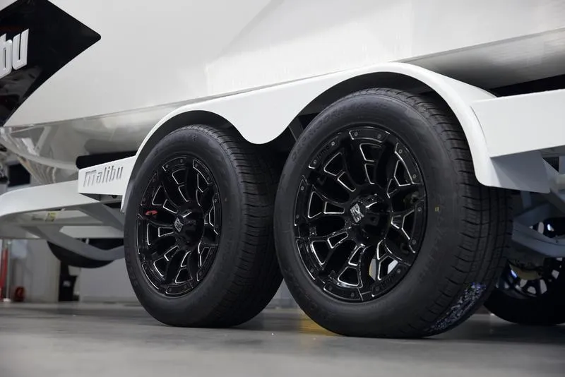 Slide: The Image of 2025 Malibu 22 MXZ trailer with sleek black wheels in a garage setting. - 9