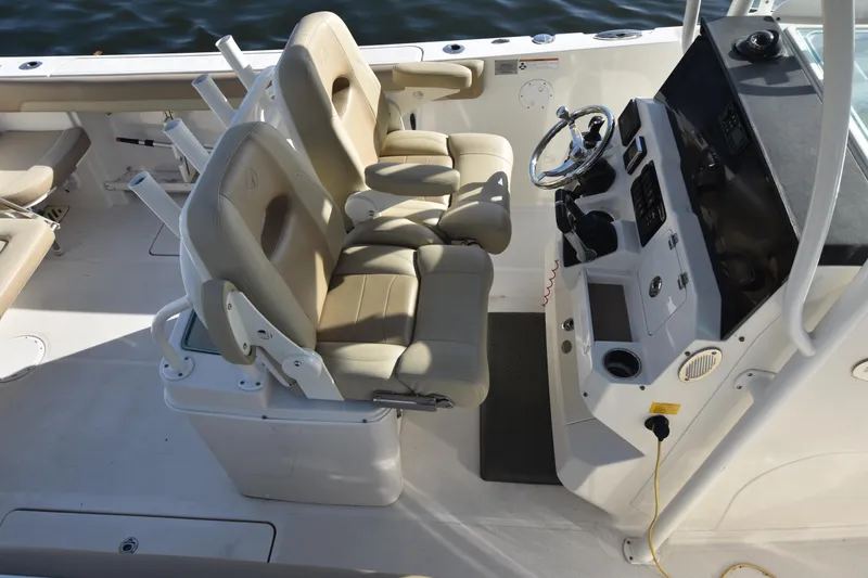 Slide: The Image of 2020 Sailfish 290 CC boat interior with dual helm seats and steering console. - 12
