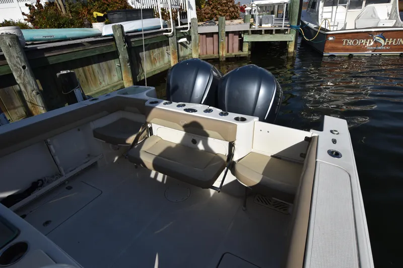 Slide: The Image of 2020 Sailfish 290 CC boat with dual engines docked at marina. - 14