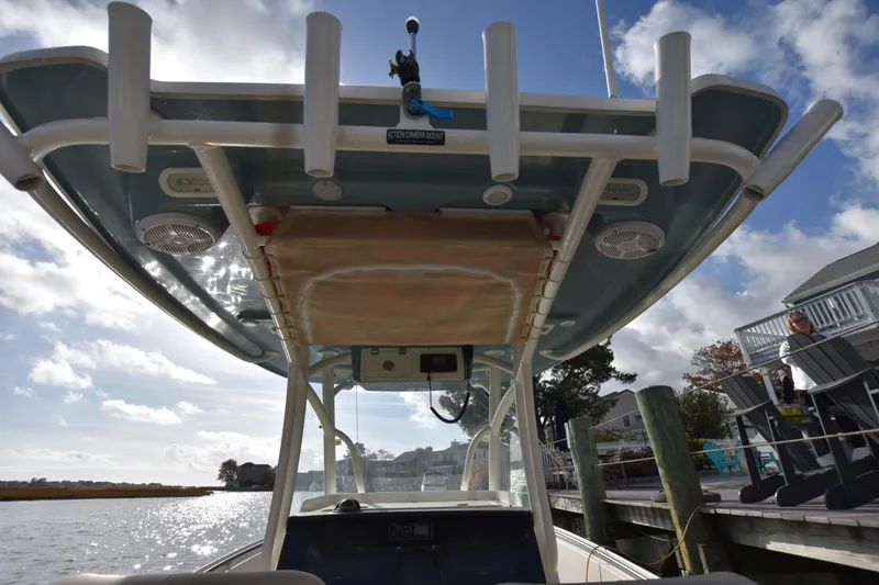 Slide: The Image of 2020 Sailfish 290 CC boat with T-top, docked by a sunny waterfront. - 34