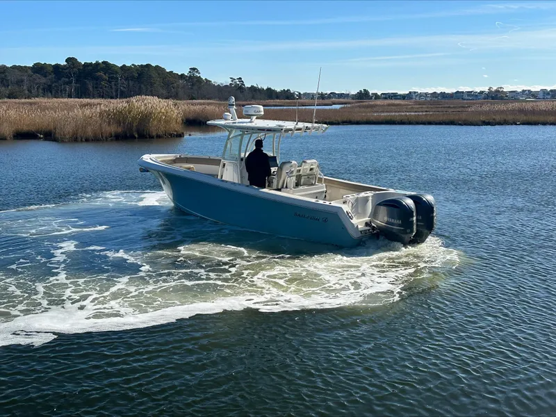 Slide: The Image of 2020 Sailfish 290 CC boat cruising on a calm lake. - 45
