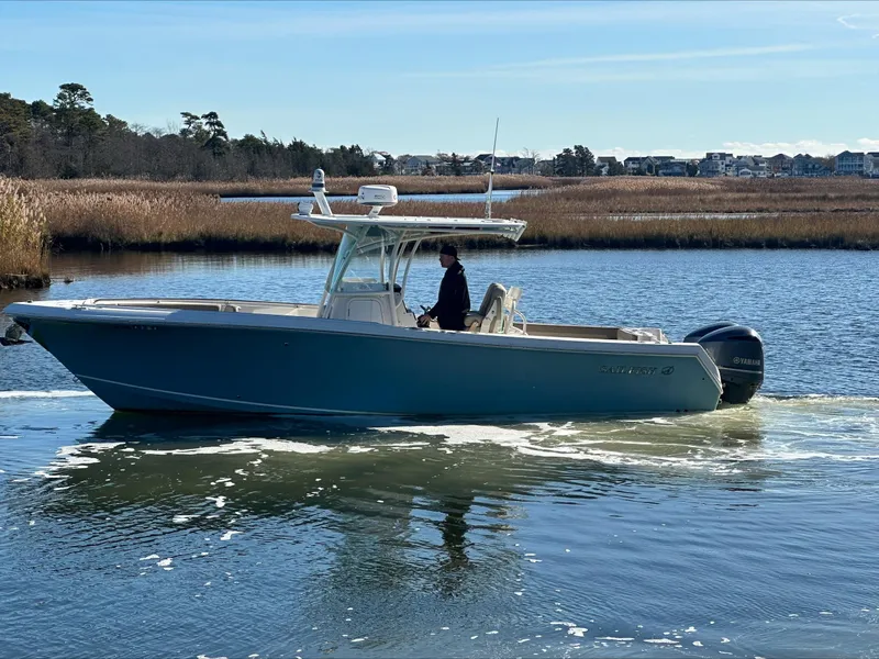 Slide: The Image of 2020 Sailfish 290 CC boat cruising on a calm river. - 47