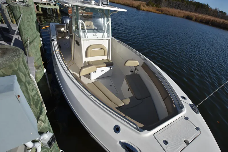 Slide: The Image of 2020 Sailfish 290 CC boat docked on calm water. - 7