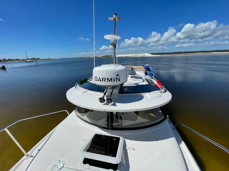 Slide: The Image of 2025 Ranger Tugs R-27 boat on calm water with Garmin radar. - 3