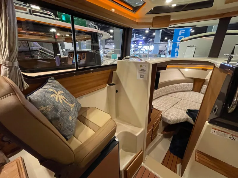 Slide: The Image of Interior of 2025 Ranger Tugs R-27 boat, featuring cozy seating and modern design. - 7